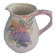 Glazed ceramic slip jug with vintage basket and fruit motif