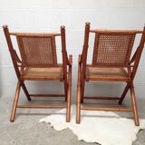 Pair of folding chairs in bamboo and caning, leather and brass