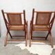 Pair of folding chairs in bamboo and caning, leather and brass