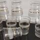 8 glasses with white granite band and gold edging from the 1950s