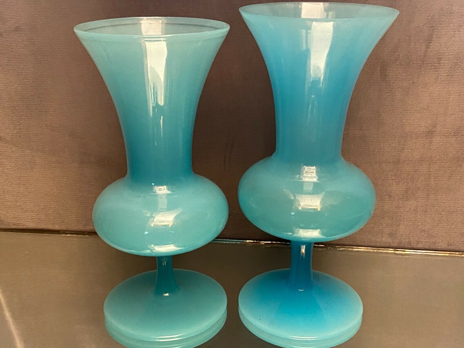 Two vases on a pedestal in blue opaline