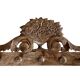 Wall-mounted coat rack on a carved wooden pediment
