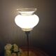 Table lamp with gold metal base and vintage white glass lampshade