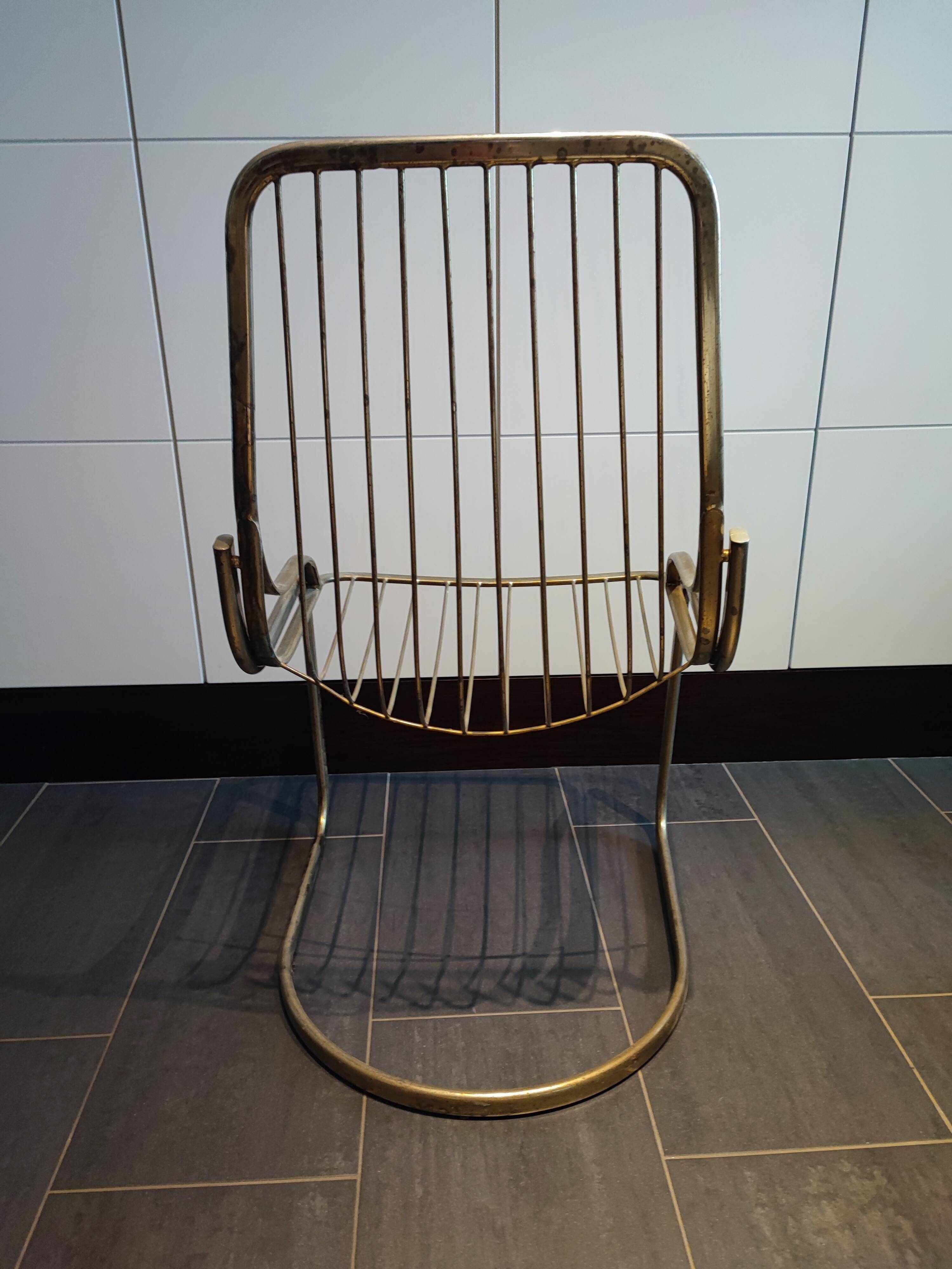 Tubular metal chair covered with gilding