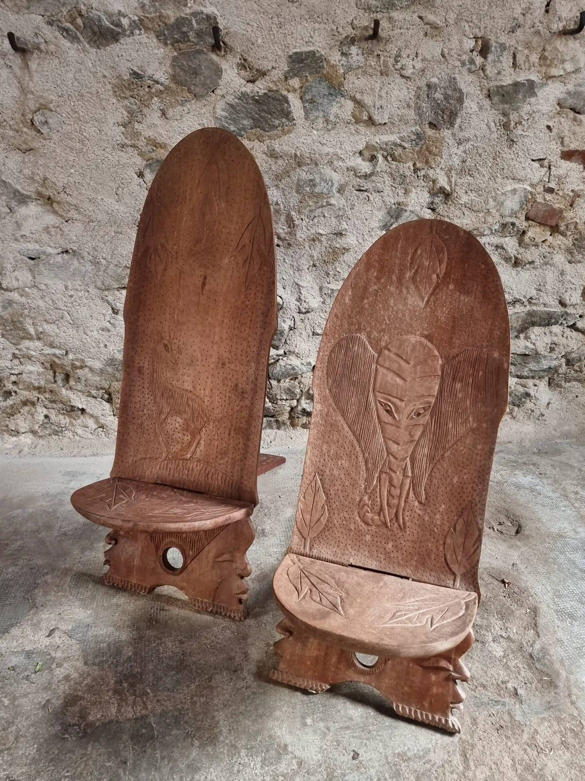 Pair of hand-carved wooden folding chairs – African origin, animal and face motifs, mid-20th century