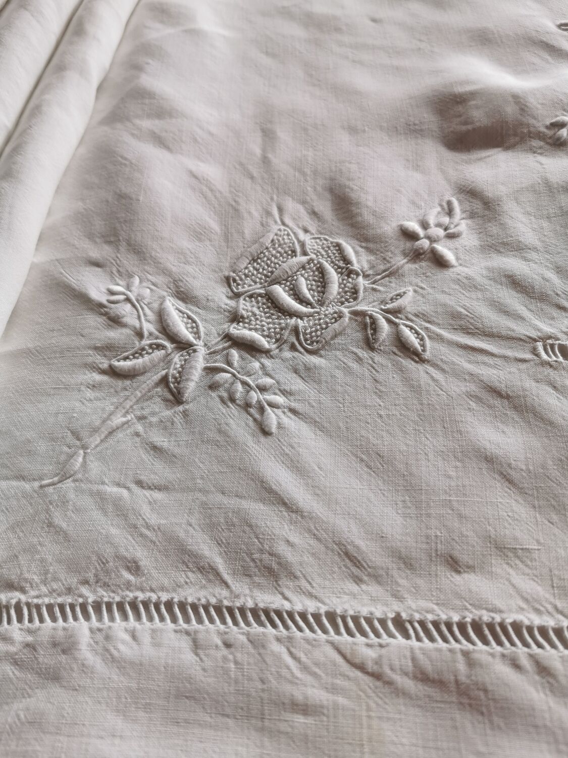 Antique embroidered linen sheet with a monogram.