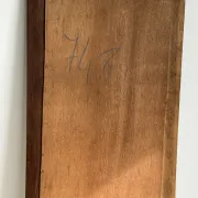 Antique mirror door (left) of a brown oak wardrobe with bevelled glass.