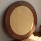 Round vintage mirror with mahogany wood effect frame.