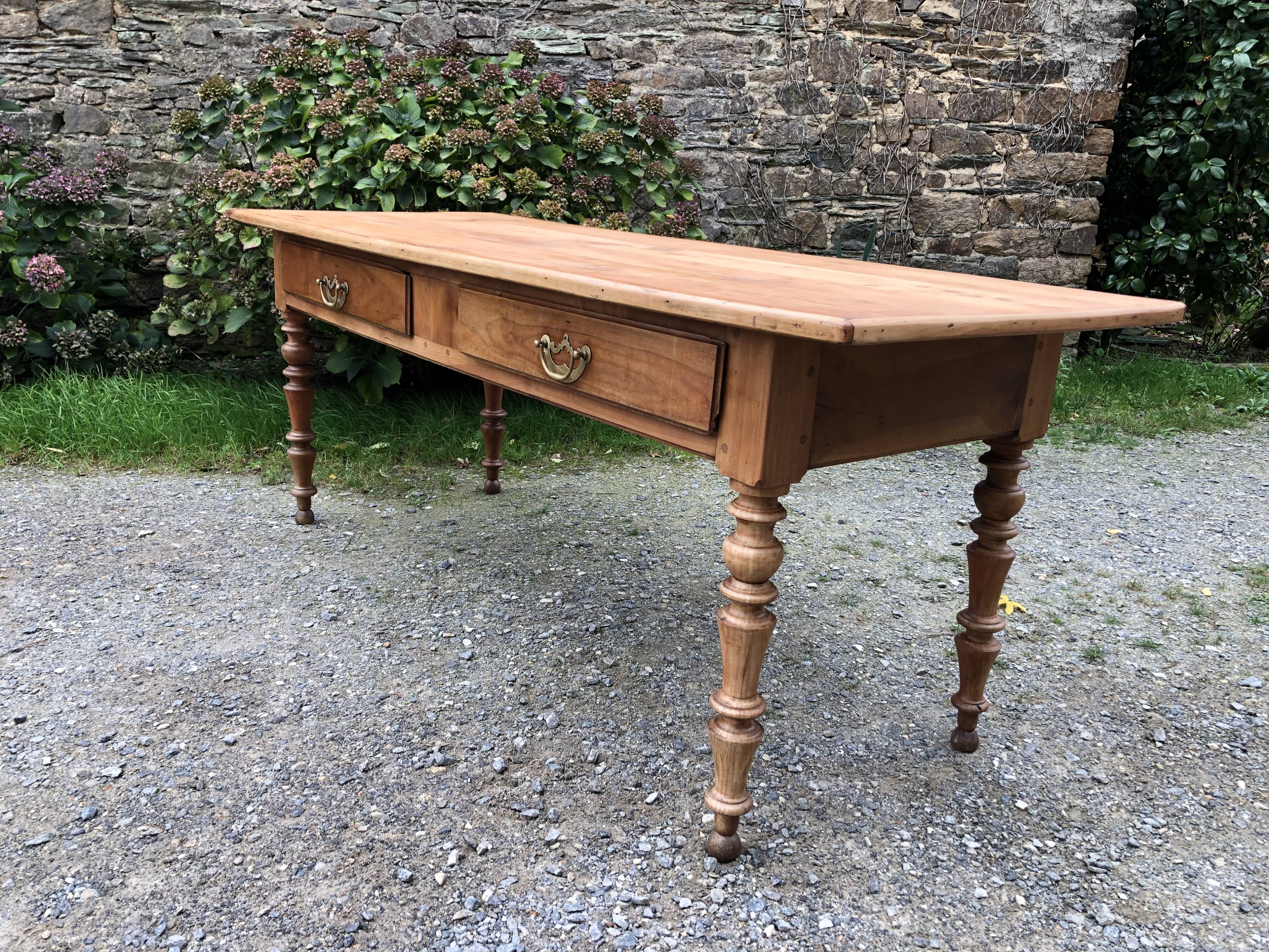 Antique Louis Philippe style farm table in solid cherry wood with 2 drawers and turned base.