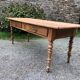 Antique Louis Philippe style farm table in solid cherry wood with 2 drawers and turned base.