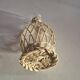 vintage glass vase surrounded by woven rattan