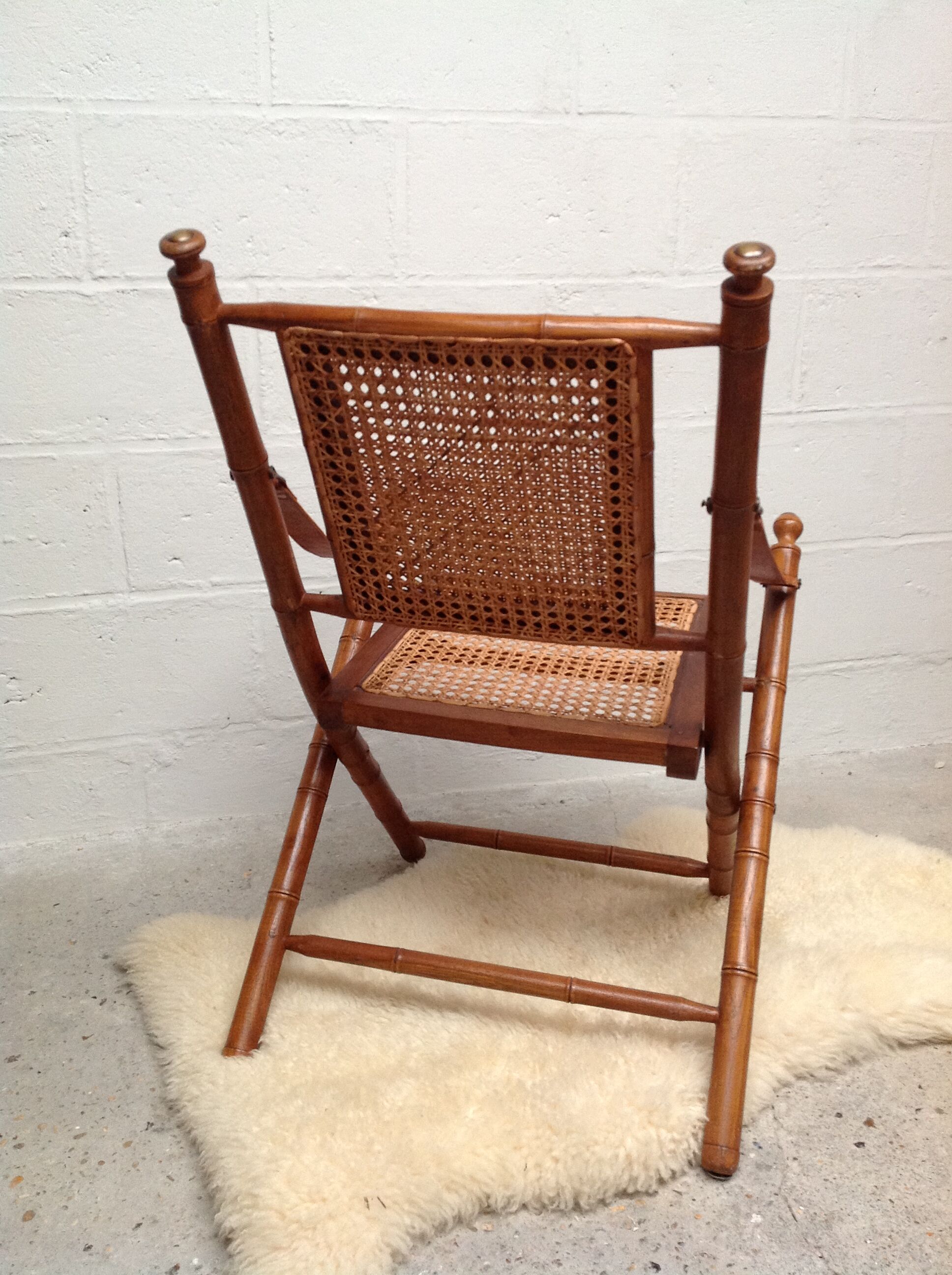 Bamboo folding armchair and caning, leather and brass