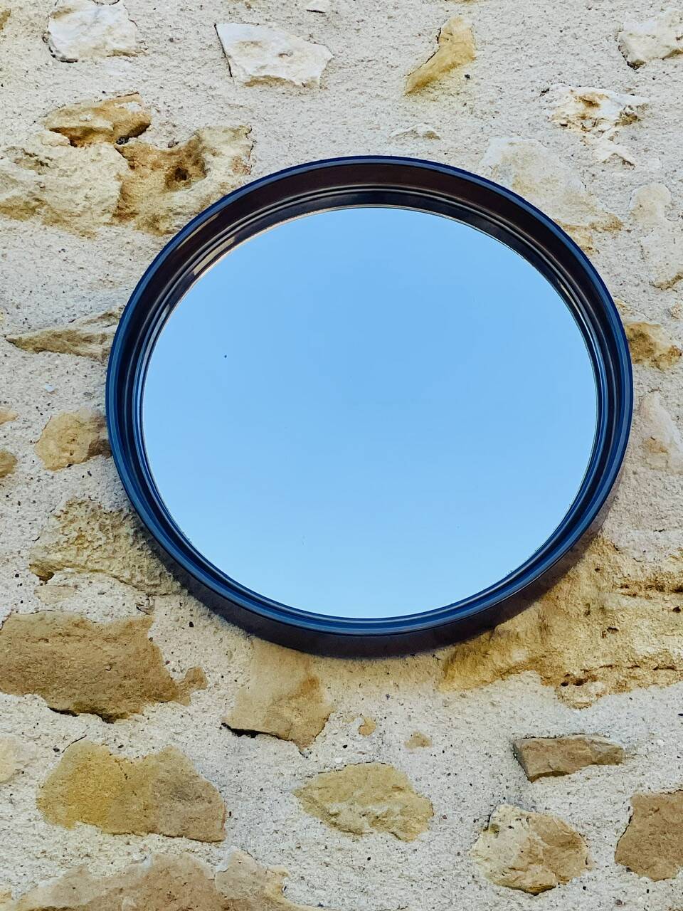 Vintage round smoked plastic mirror, circa 1970s.
