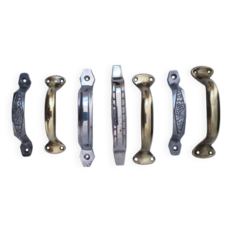 Seven art deco silver tone and brass handles