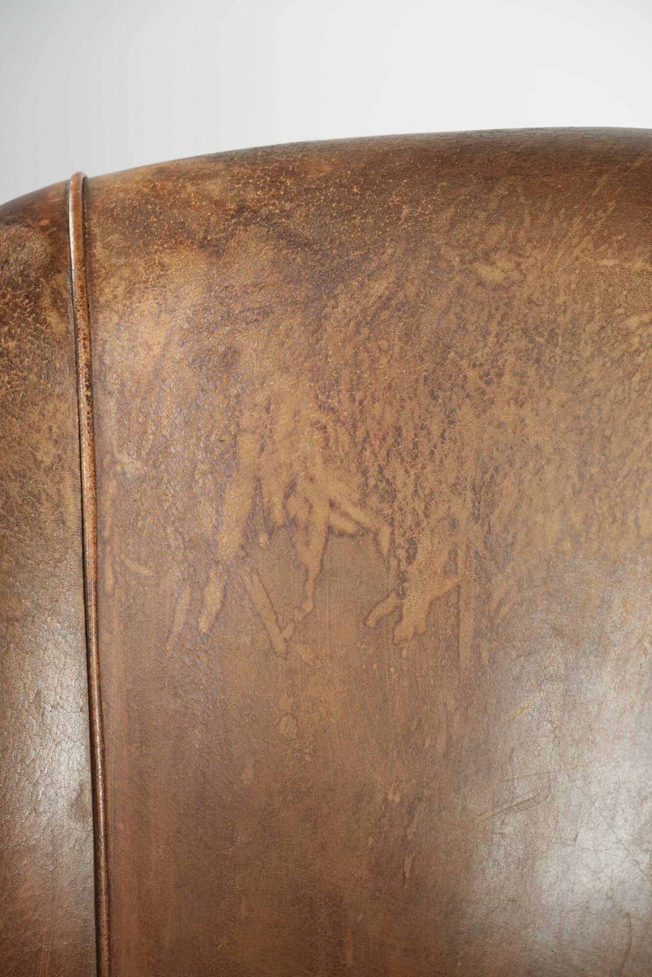 Vintage sheepskin club armchair finished with decorative nails