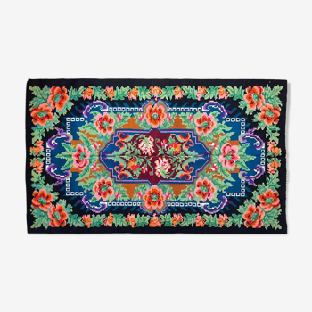 Rug with floral design on a blue background made by hand in Romania