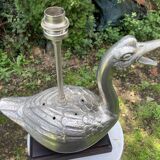 Old vintage lamp representing a duck in silver metal with wooden base