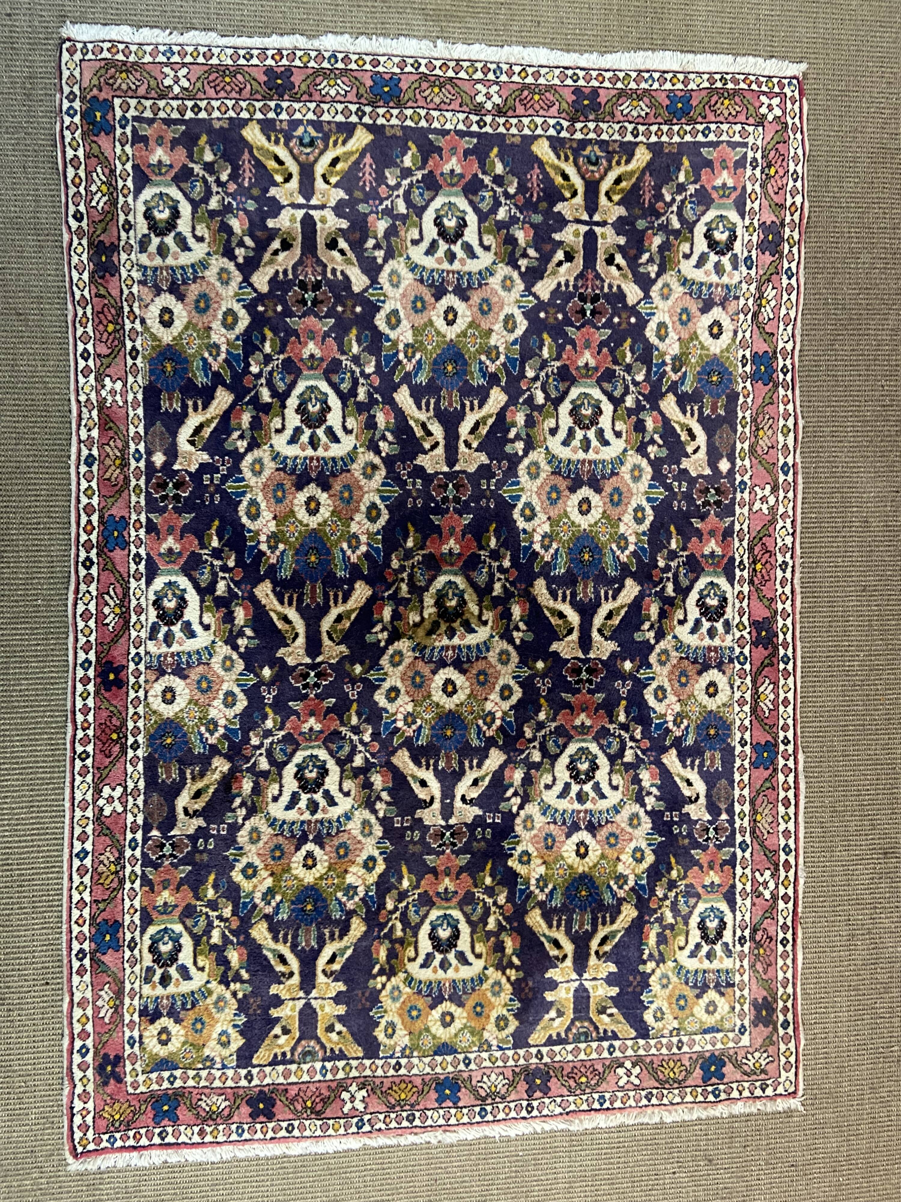 Antique Oriental rug from a nomadic tribe, 1950-1980, birds on a purple background