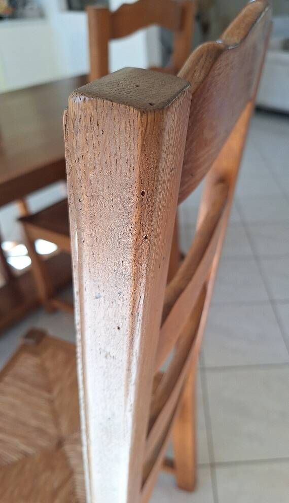 Set of 6 solid oak chairs with straw seats.