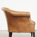 Very comfortable, elegant leather club armchair with a removable seat cushion and timeless design