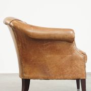 Very comfortable, elegant leather club armchair with a removable seat cushion and timeless design