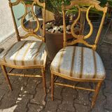Pair of chairs with a golden lyre