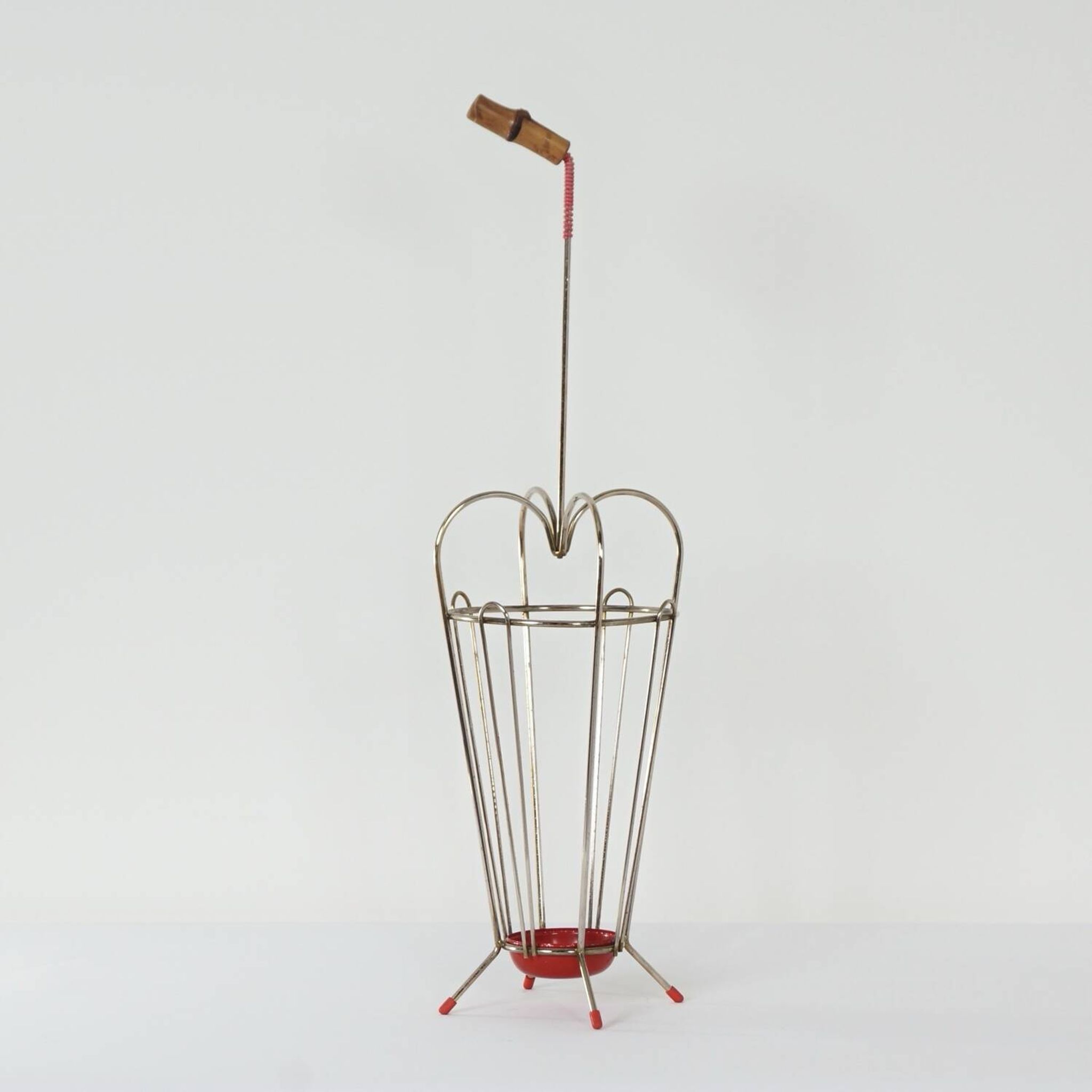 VINTAGE UMBRELLA STAND OF CURVED METAL, RED DETAILS AND A BAMBOO HANDLE, 1950S