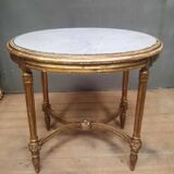 Oval coffee table in gilded wood in the Louis XVI style.