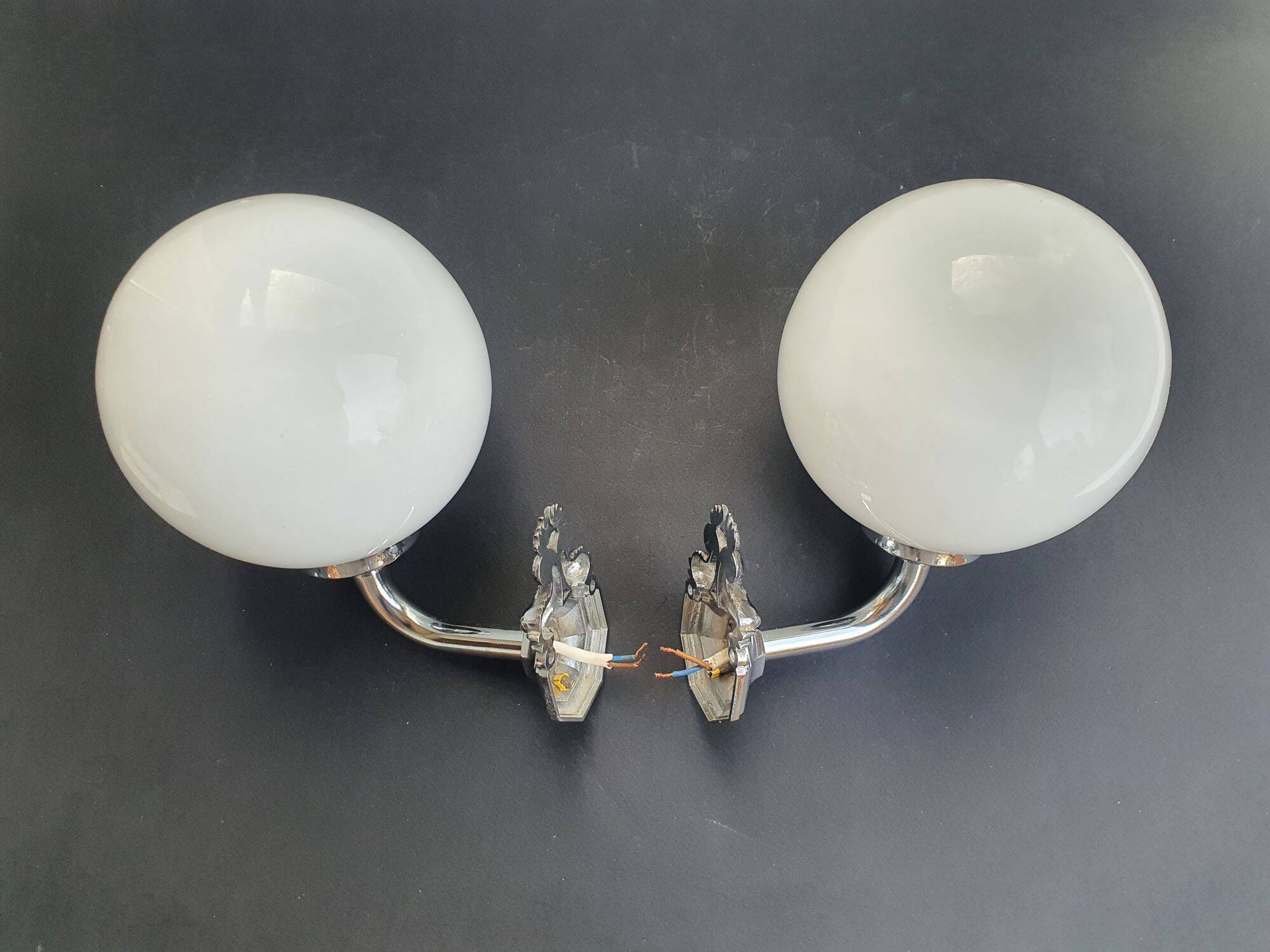 Pair of chrome wall sconces for bathroom with vintage fish pattern.