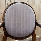 Pair of Louis XVI cabriolet armchairs with medallion backrest.