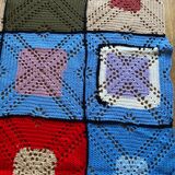 Hand-knitted patchwork blanket