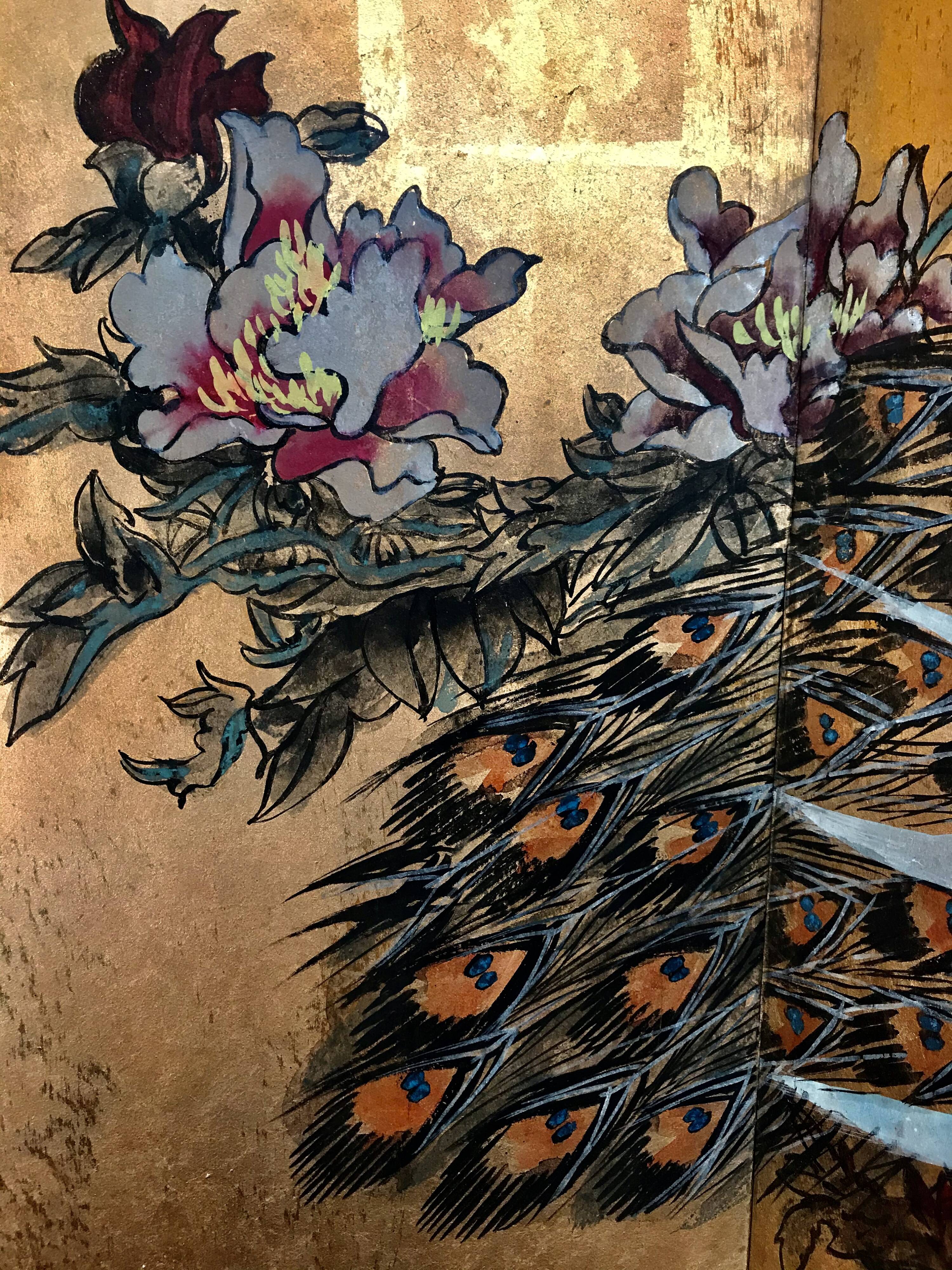 Ancient Chinese screen decorated with peacocks and flowers on gold leaf