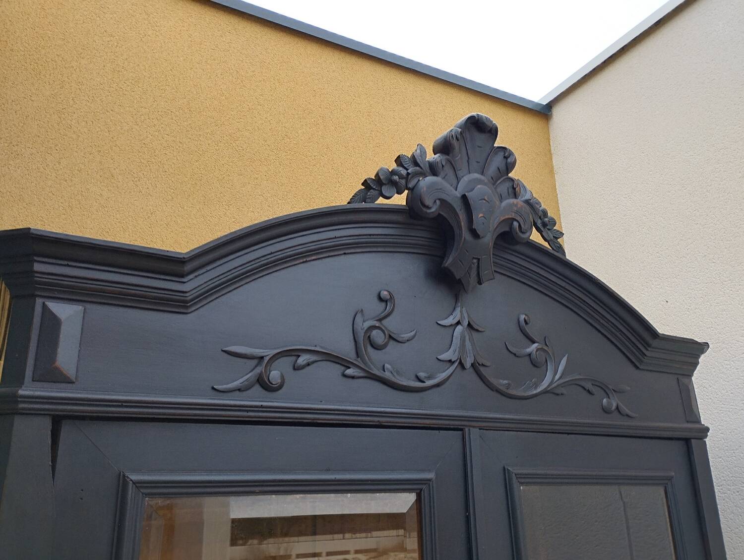 Bookcase black patina shell pediment 2 drawer doors