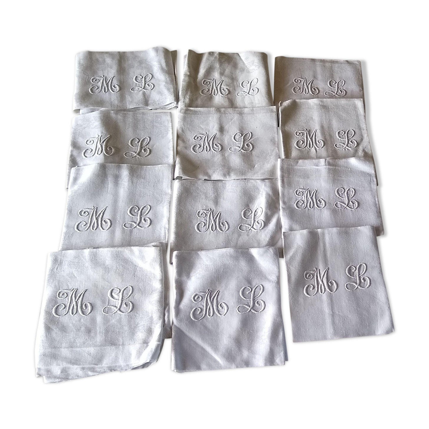 12 large antique damask towels with floral decoration and embroidered with the ML monogram