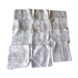 12 large antique damask towels with floral decoration and embroidered with the ML monogram