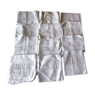 12 large antique damask towels with floral decoration and embroidered with the ML monogram