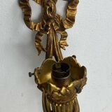 Bronze wall light, decorated with a bow and ribbon.