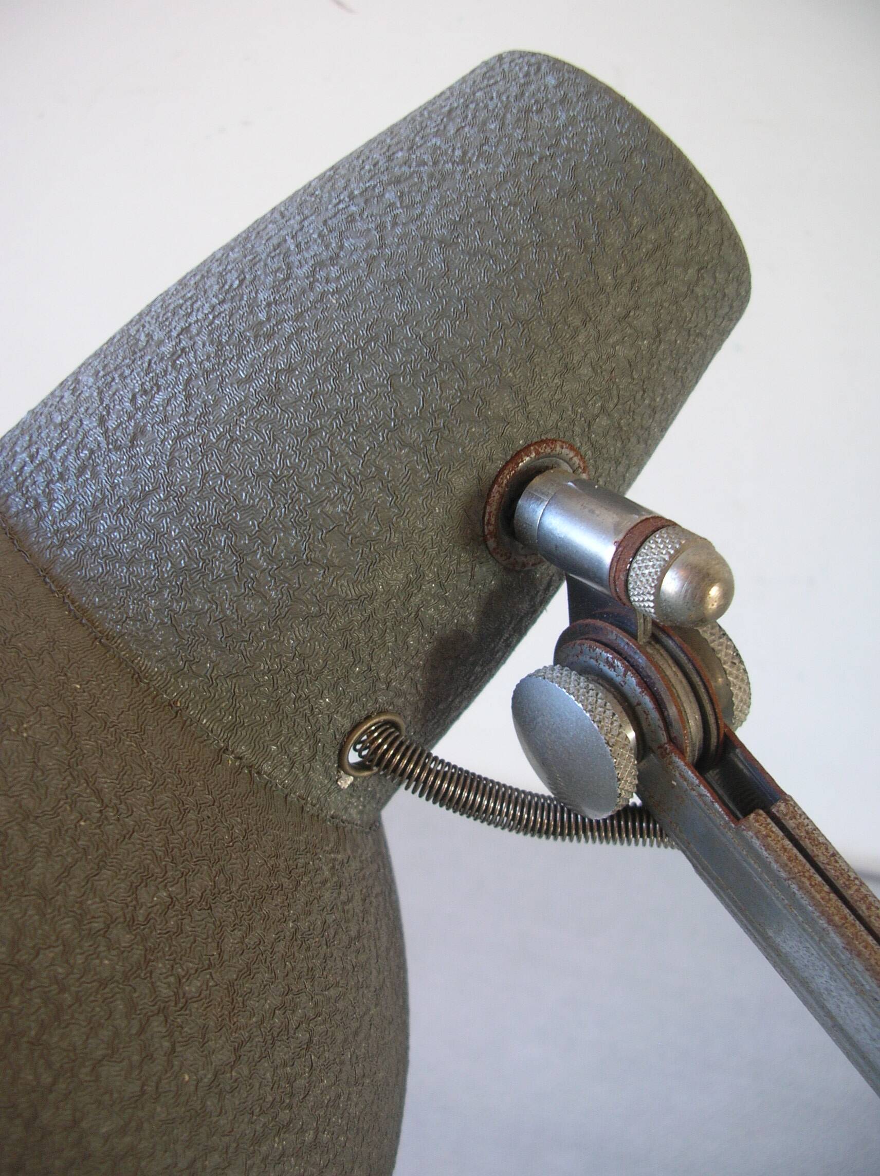 Super Chrome old articulated metal desk lamp on workshop decor base