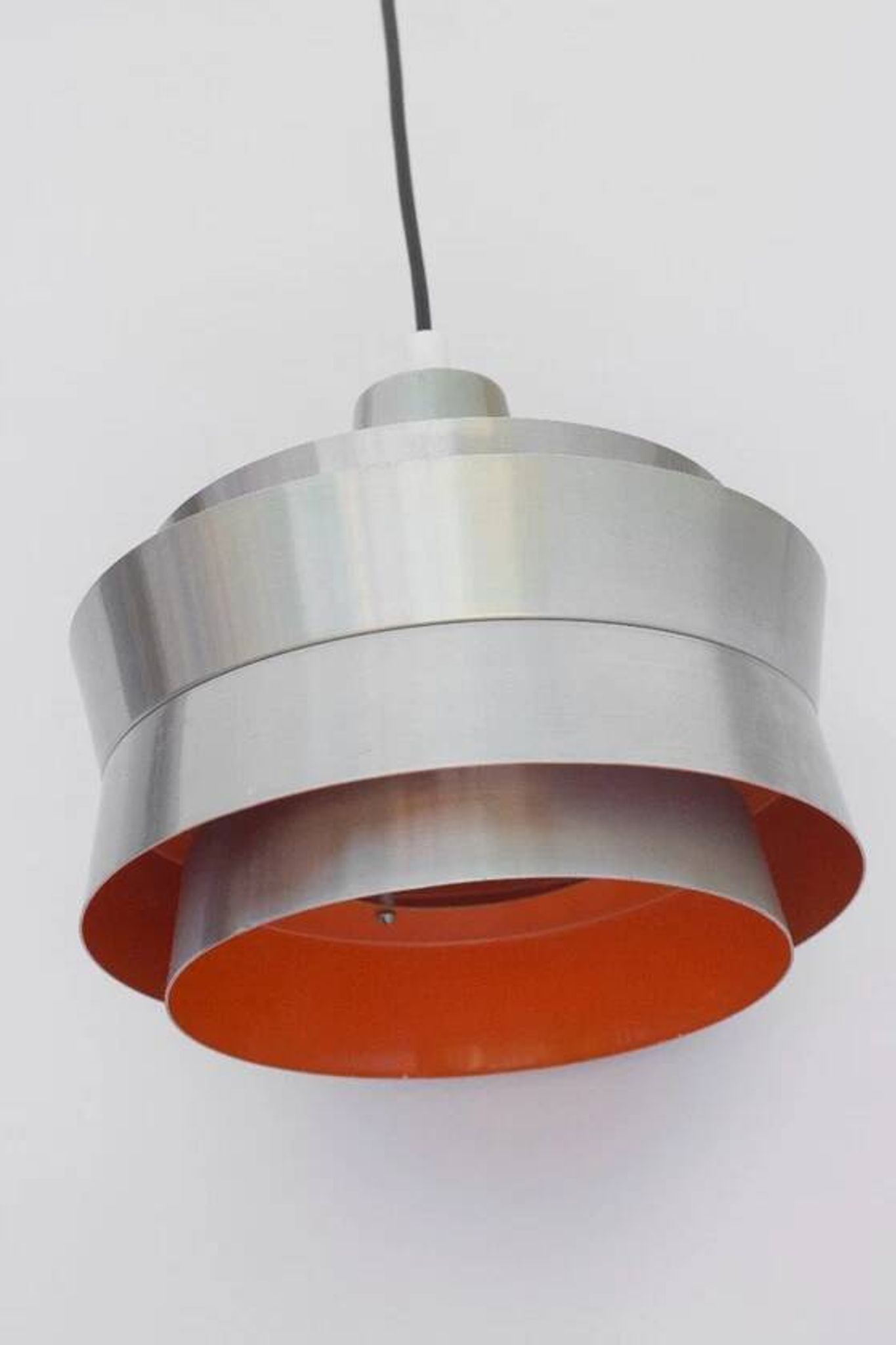 Carl Thore's Trava lamp in aluminium with an orange lacquered interior.