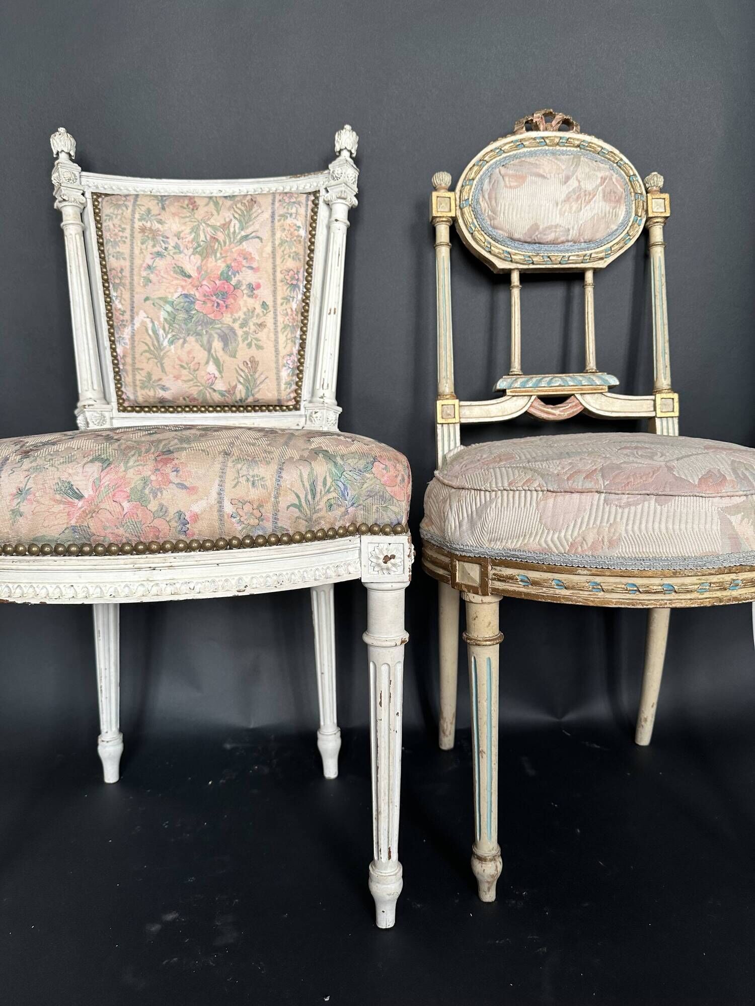 Antique Louis XVI style chair with patinated wood and floral fabric.
