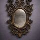 Antique Louis XV style mirror, richly carved with decorations of scrolls, shells, and foliage.