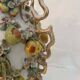 Large antique vase with relief decorations of coloured fruits.