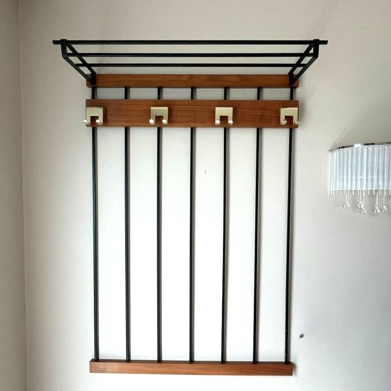 Wall-mounted coat rack in wood and black.