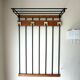 Wall-mounted coat rack in wood and black.