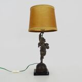 Old table lamp in repel, cherub, angel, cherub, putti with a bird in hand. 1930s