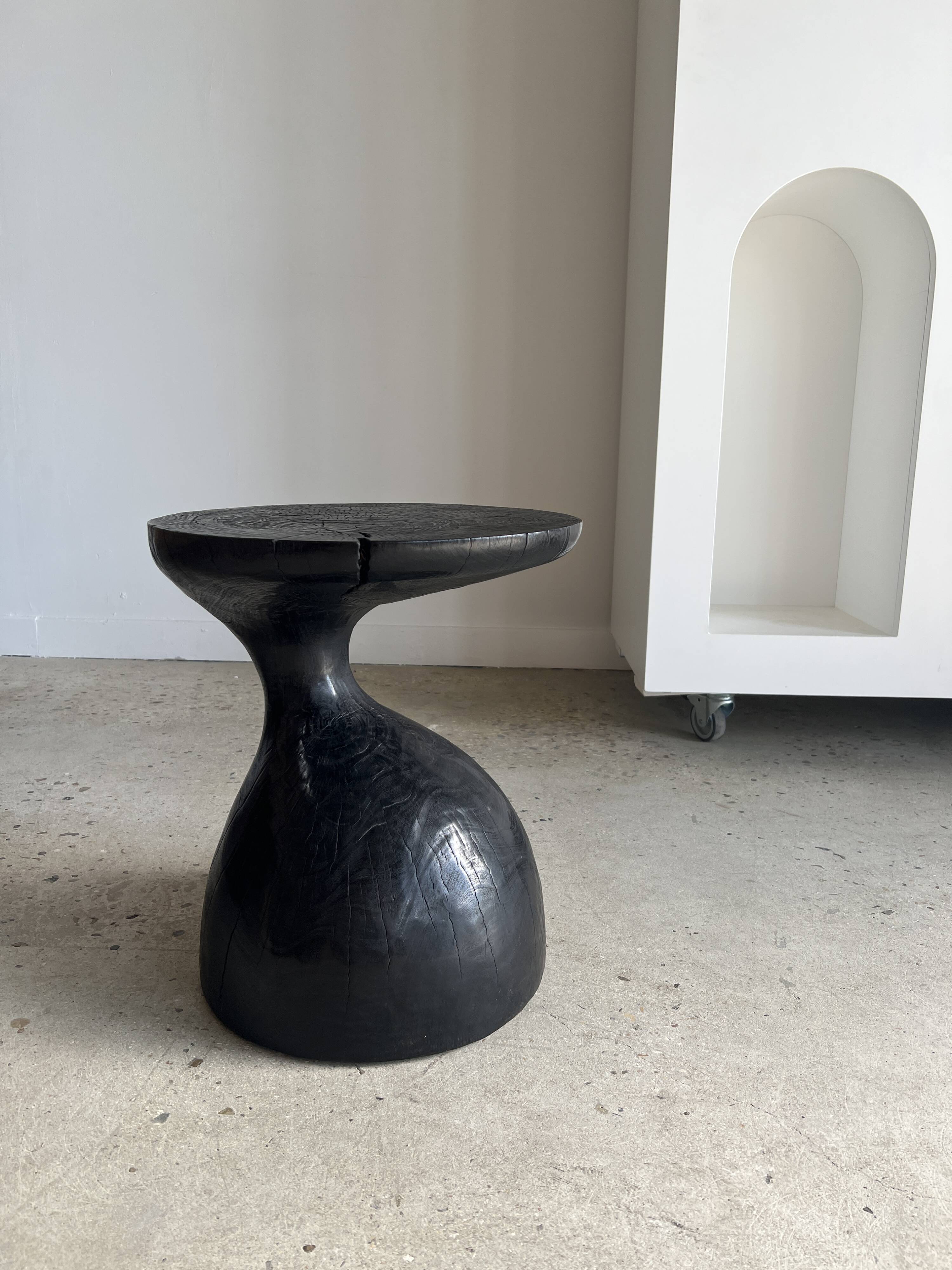 Solid wood (monoxyl) side table, organic shape, black color