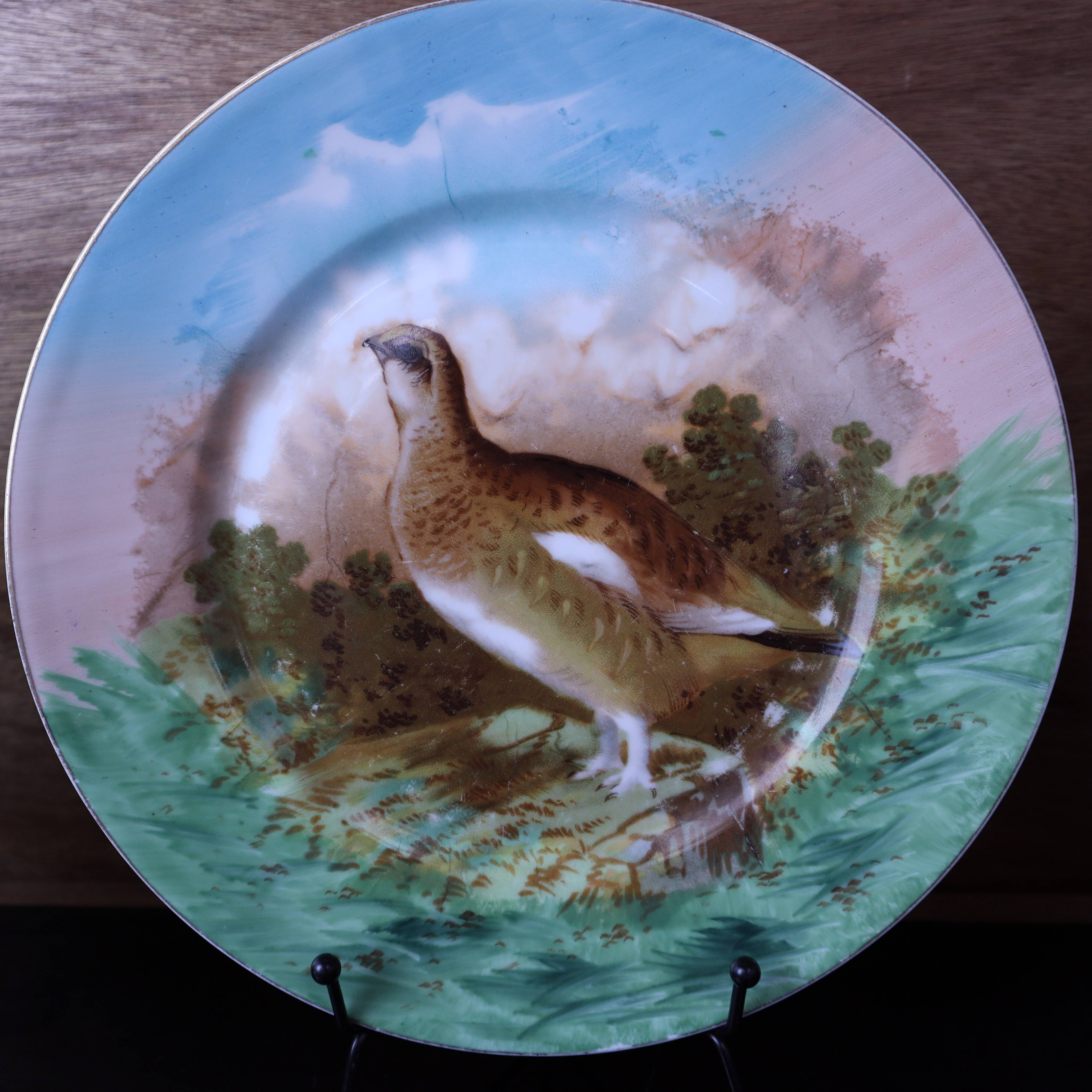 3 decorative porcelain plates from Limoges featuring partridges and pheasants.