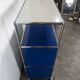 USM Haller furniture in gentian blue and white with a drop-down door on wheels.