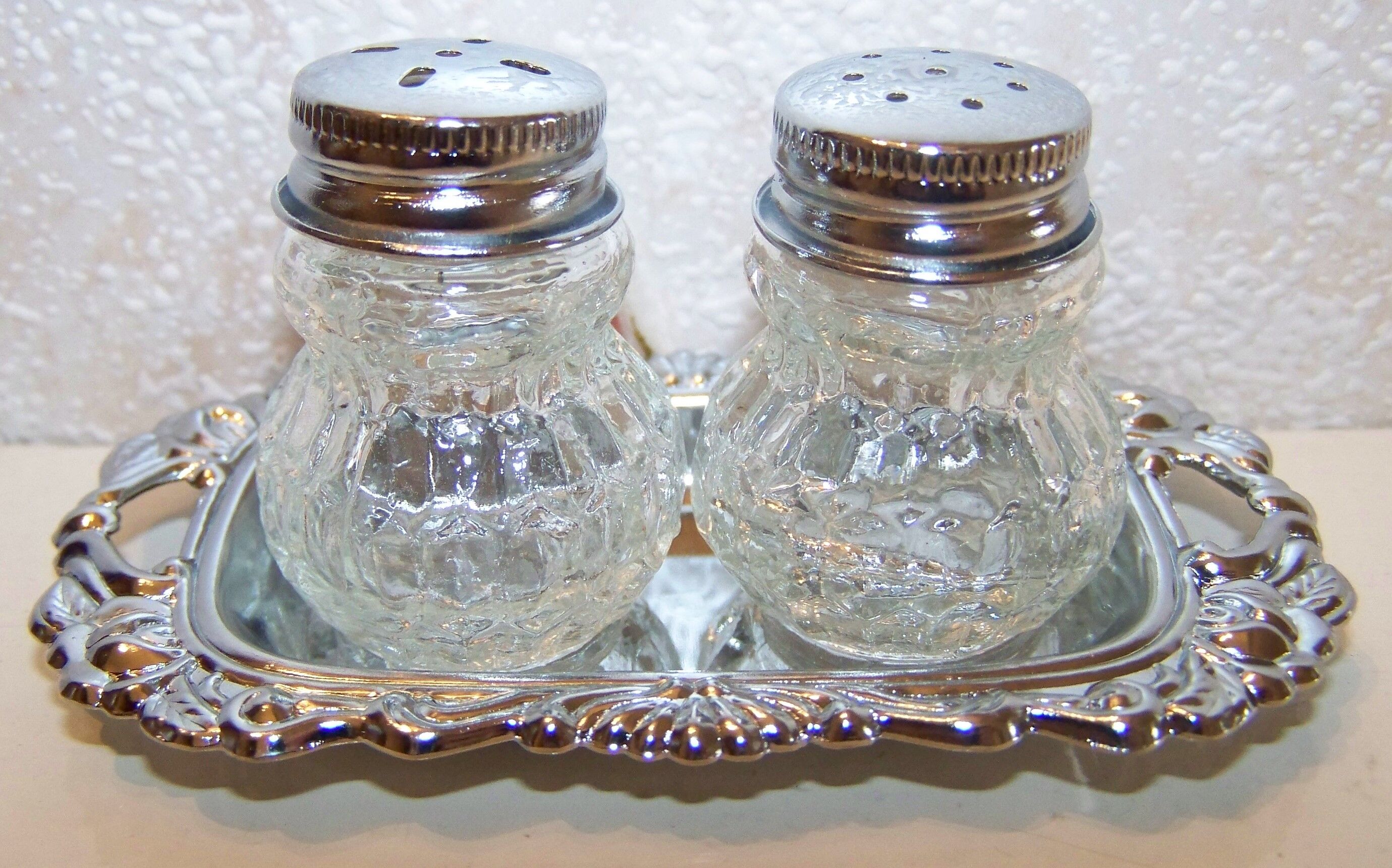 Salt shaker, pepper pot on a silver tray