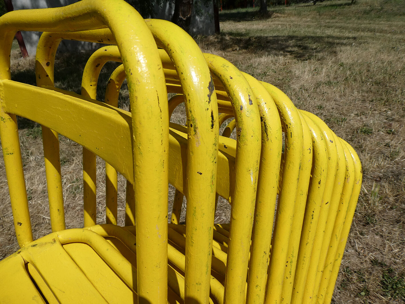 Lot of 11 yellow metallic bistro chairs from the 1950s